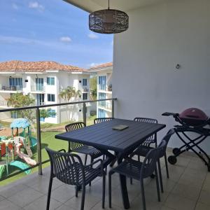 a patio with a table and chairs and a grill at Rio Mar Villages in San Carlos