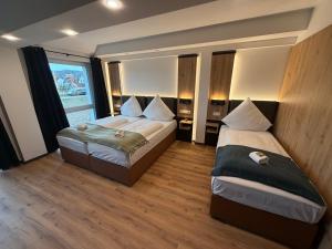 a bedroom with two beds and a window at AS-Hotel NOM in Northeim +26 photos