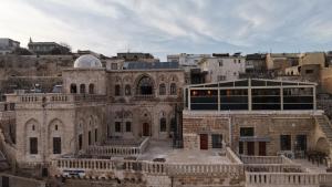 an old building in a city with a building at Helen Olimpos Konağı in Mardin