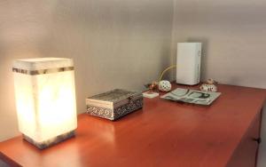 a desk with a lamp and a box on it at Sky Loft La Melissa - Pisa Center in Pisa
