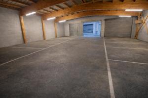 an empty garage with a garage door and a parking lot at Hôtel du Palais in Évian-les-Bains +31 photos