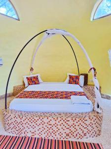 a bedroom with a bed with a wicker bed frame at La Maison Chocolat in Nianing