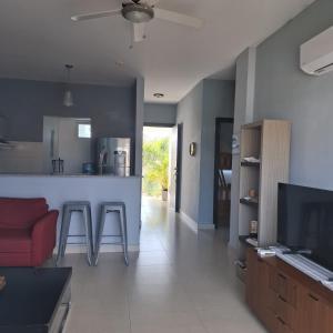 a kitchen and living room with a couch and a counter at Rio Mar Villages in San Carlos