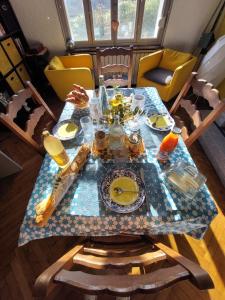 a table with plates of food on top of it at Cocorico in Boué