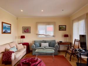 a living room with a couch and a table at Casa Varanda do Mar in Capelas