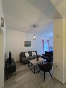 a living room with a couch and a table at Vila Oaza in Trebinje