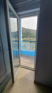 an open door to a room with a view of a balcony at Sea & Sky apartment in Skataj