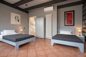 a bedroom with two beds in a room at Alloggi Nell's in Cornedo Vicentino
