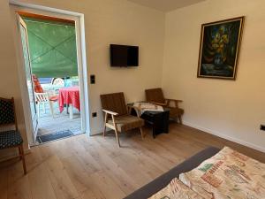 a room with a bed and a table and a window at Yellow Rose in Balatongyörök