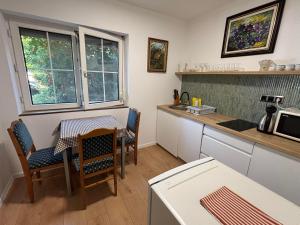 a kitchen with a table and chairs and a microwave at Yellow Rose in Balatongyörök