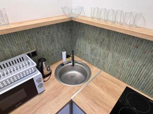 a kitchen counter with a sink and a microwave at Yellow Rose in Balatongyörök +36 photos