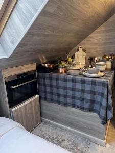a kitchen with a table with dishes on it at La'Mansarda in Chişinău