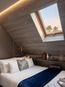 a bedroom with a large bed with a window at La'Mansarda in Chişinău