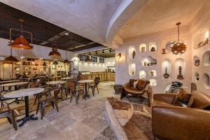 a restaurant with tables and chairs in a room at WM Cappadocia in Nevşehir