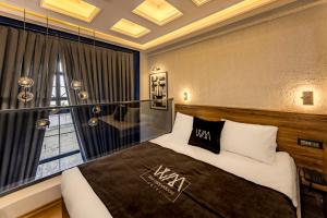 a bedroom with a large bed and a window at WM Cappadocia in Nevşehir