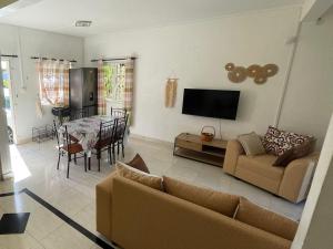 a living room with a couch and a table at Triplex - Suite parentale in Grande Gaube