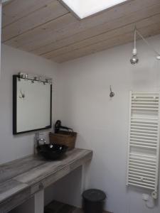 a bathroom with a sink and a mirror on the wall at La Saline in Le Palais +29 photos
