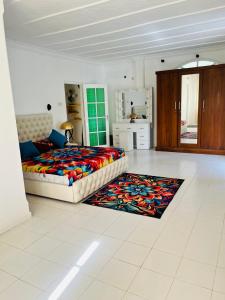 a bedroom with a large bed and a rug at Benthota grand villa in Nakandalagoda