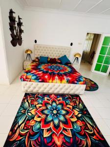 a bedroom with a bed with a colorful psychedelic bedspread at Benthota grand villa in Nakandalagoda