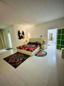 a living room with a bed and two rugs at Benthota grand villa in Nakandalagoda +4 photos
