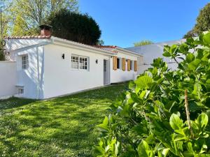 an exterior view of a white house with a yard at Casa La Finca in Vigo
