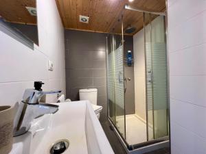 a bathroom with a glass shower and a sink at Casa La Finca in Vigo +17 photos