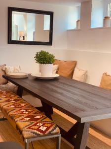 a wooden table with a potted plant on top of it at Peartree Cottage in Sandhoe