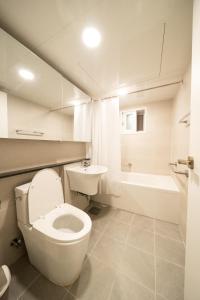 a white bathroom with a toilet and a sink at Banghwa Space 5 min to Banghwa Stn, Near Gimpo Airport, Magok & COEX in Seoul +36 photos