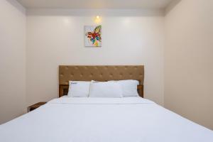 a bedroom with a large bed with white sheets at Cannan Residency Pondicherry in Pūrnānkuppam +37 photos
