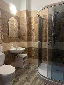 a bathroom with a shower and a toilet and a sink at AtmosferA in Bydgoszcz +89 photos