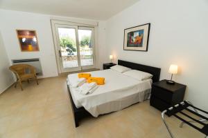 a bedroom with a bed with a orange toy on it at Il Giardino Dei Carrubi in Donnalucata +73 photos