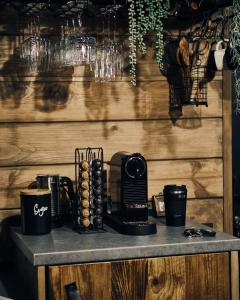 a table with a coffee maker on top of it at BRUN Cabin in Şotrile