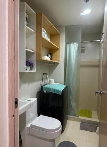a bathroom with a toilet and a shower at UrbanGem Iloilo in Iloilo City