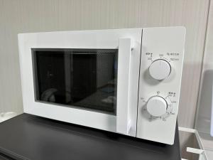 a white microwave oven sitting on top of a counter at つんまぁー家 in Miyakojima