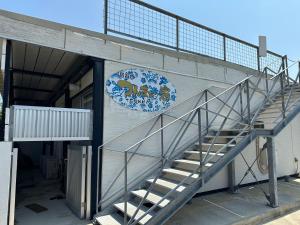 a building with a spiral staircase in front of it at つんまぁー家 in Miyakojima