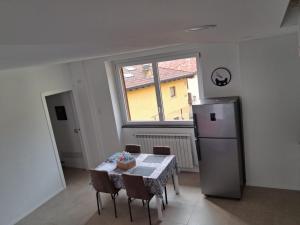 a kitchen with a table and a refrigerator at Il Borgo in Lurago D'Erba  +30 photos