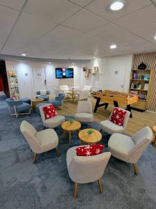a room with chairs and tables and a pool table at ibis Grenoble Centre Bastille in Grenoble