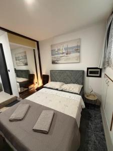 a bedroom with a bed with two towels on it at Dragazzo studio in Trogir