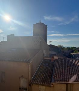 a view of roofs of buildings with a building in the background at Agde centre historique avec vue in Agde