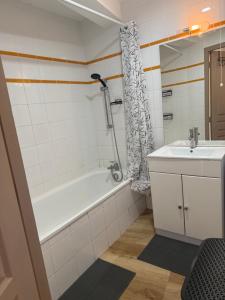 a bathroom with a bath tub and a sink at Agde centre historique avec vue in Agde