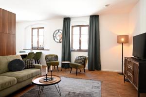 a living room with a couch and chairs at Pension Donatus in Pirna