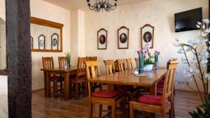 a dining room with wooden tables and chairs at Pension Arietta in Plauen