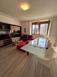 a living room with a red couch and a table at Le Style Haussmannien in Tramelan
