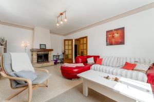 a living room with a couch and a table at Maison proche Vaison la Romaine in Saint-Romain-en-Viennois