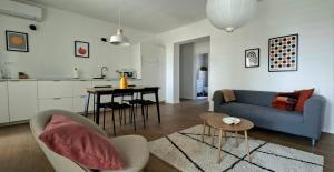 a living room with a blue couch and a table at Apartments Daria in Krk