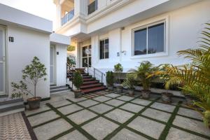 a house with plants in front of it at Cannan Residency Pondicherry in Pūrnānkuppam