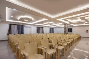 an empty room with rows of chairs in it at Cannan Residency Pondicherry in Pūrnānkuppam