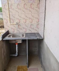 a bathroom with a sink in a wall at Hotel B B Pride in Raipur