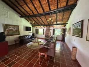 a living room with a couch and a table at Finca Las Flores in El Cedro