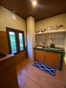 a kitchen with a sink and a counter top at Nature Nest in Manāli
